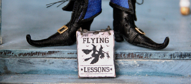 witch's feet with flying lessons sign