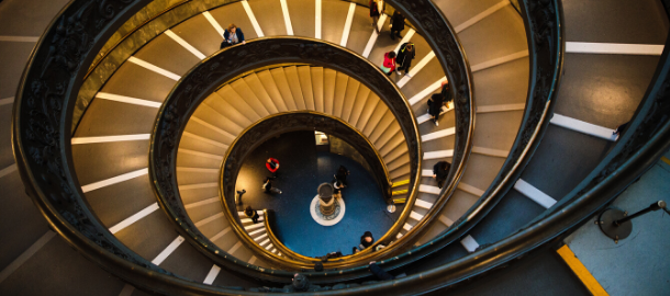 looking down a spiral staircase with people on it