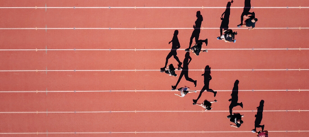 runners on a track in v formation