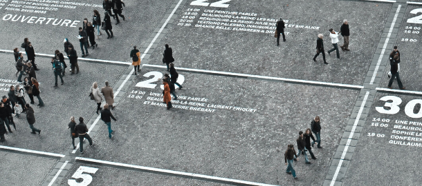 people standing in numbered boxes