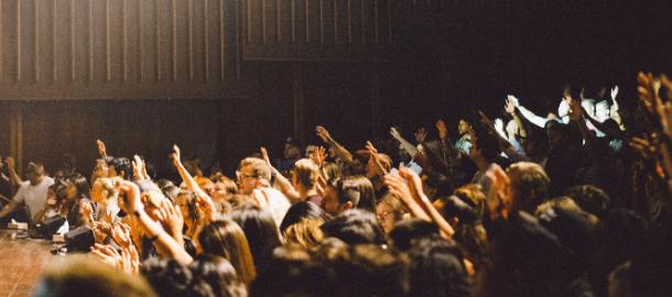 audience with hands raised